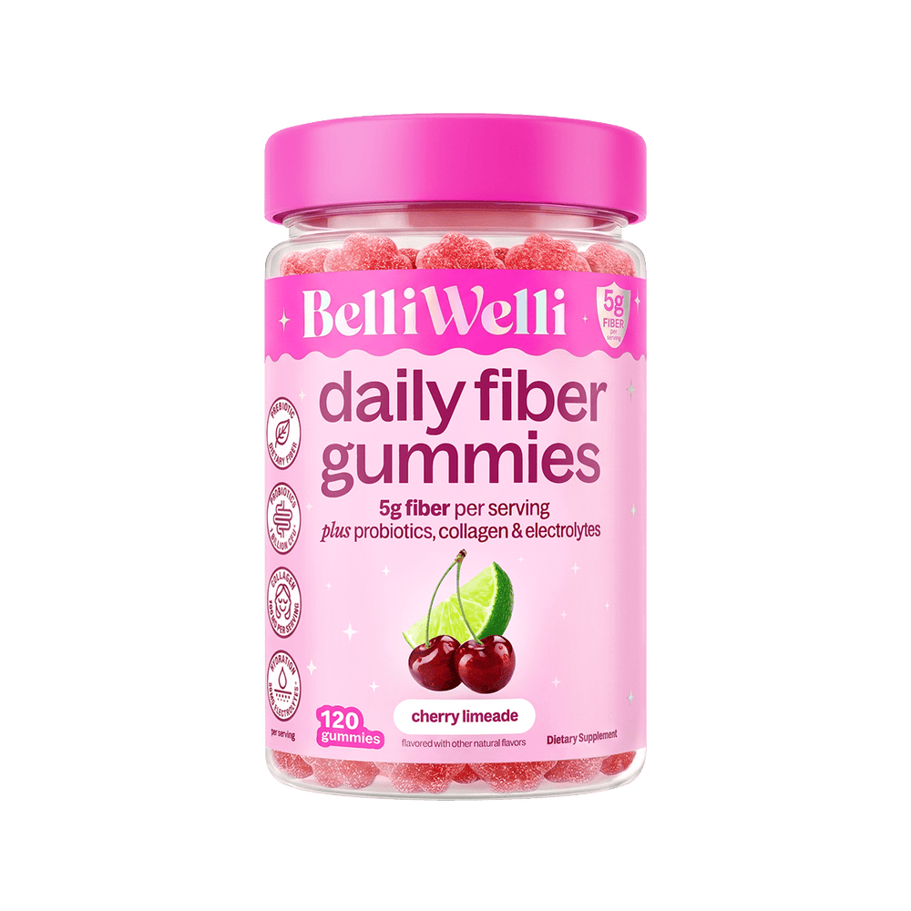 A bottle of BelliWelli Daily Fiber Gummies in cherry limeade flavor, featuring a bright pink cap and a pink label with a cherry and lime graphic, set against a plain white background.